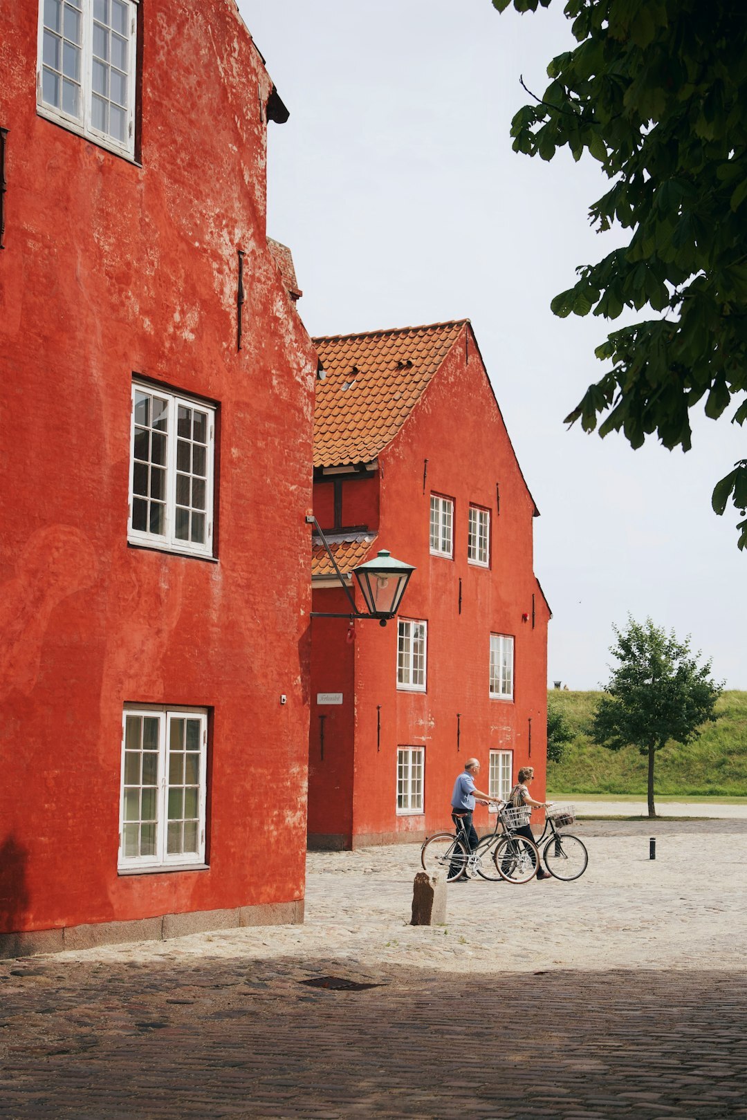 Archival style black and white photo of a small Danish town square with bicycles