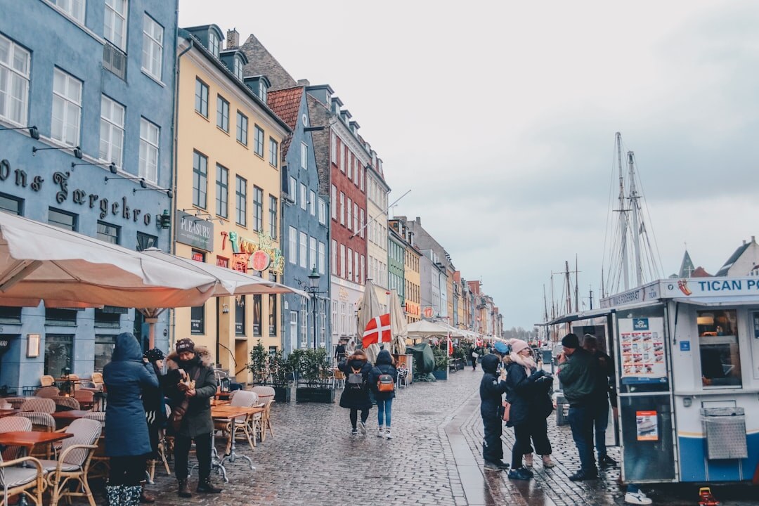 Small diverse team of photographers and journalists standing together outdoors in Copenhagen