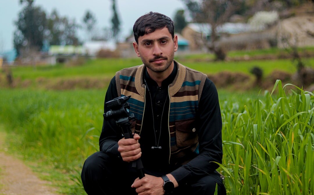 Portrait of a Danish male video journalist with a beard holding a video camera